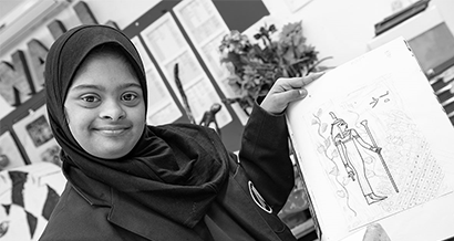 Girl showing drawing of Egyptian